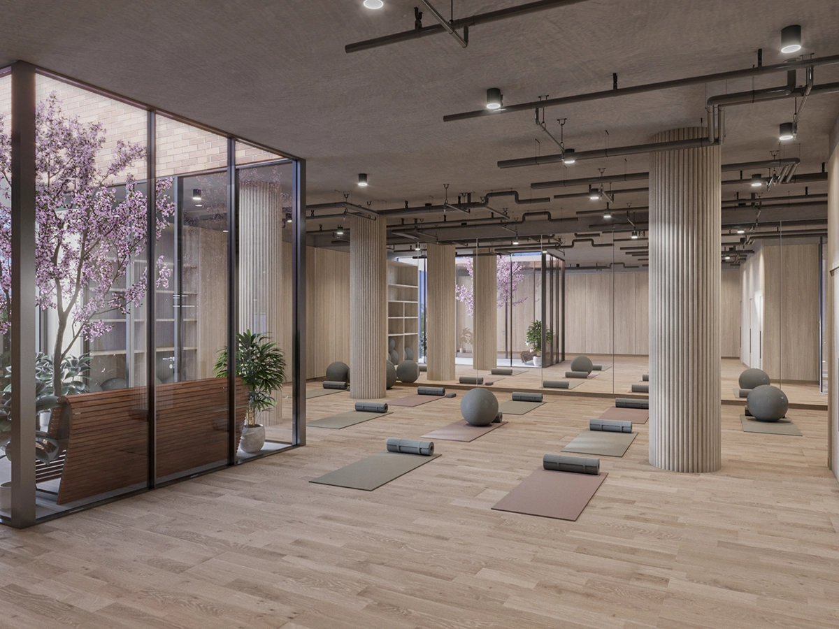 Visualisation de l'aménagement de bureau d'un studio de yoga avec sol en bois, colonnes nervurées, balles de méditation et paroi vitrée avec arbres en fleurs
